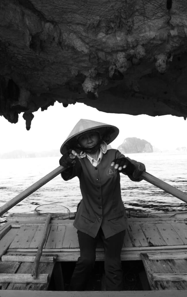 Woman on bamboo boat in Halong Bay Vietnam